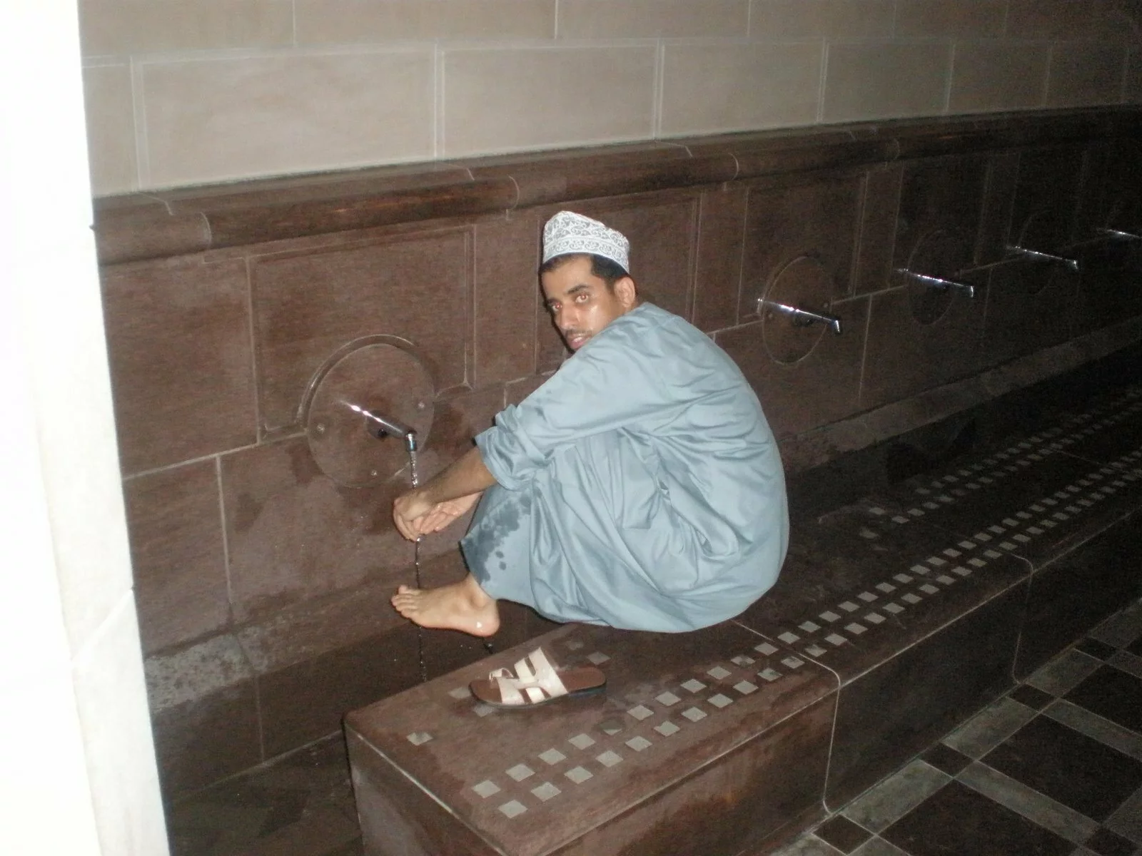 Bader making wudu at Sultan Qaboos Grand Mosque